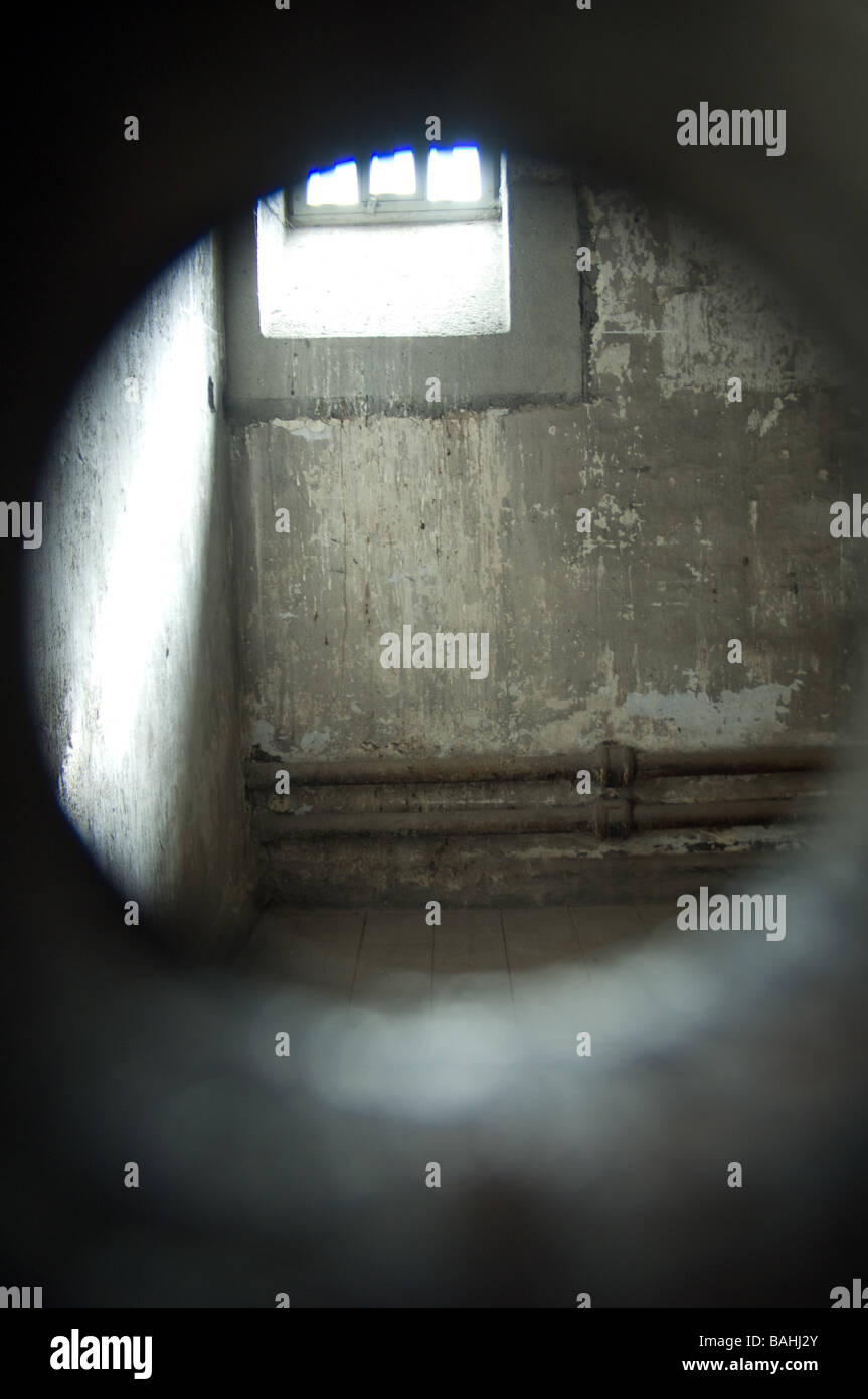 Looking through the peephole into empty prison cell at Kilmainham gaol, Dublin, Ireland Stock Photo