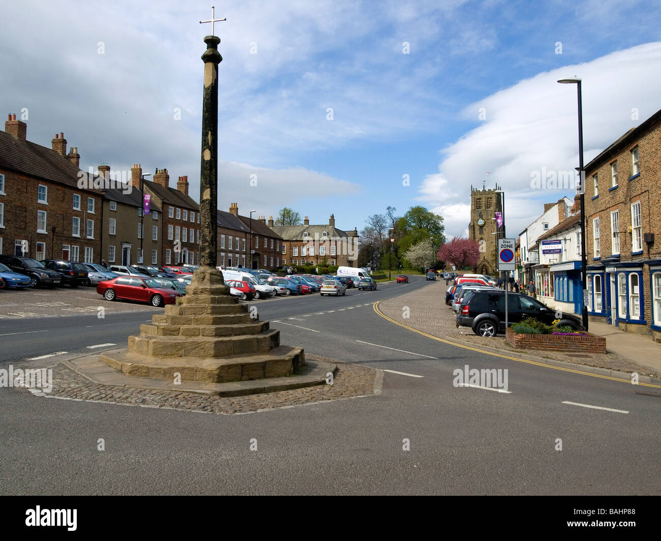 Market Cross and the church of St Gregory North End Bedale North Yorkshire UK Stock Photo