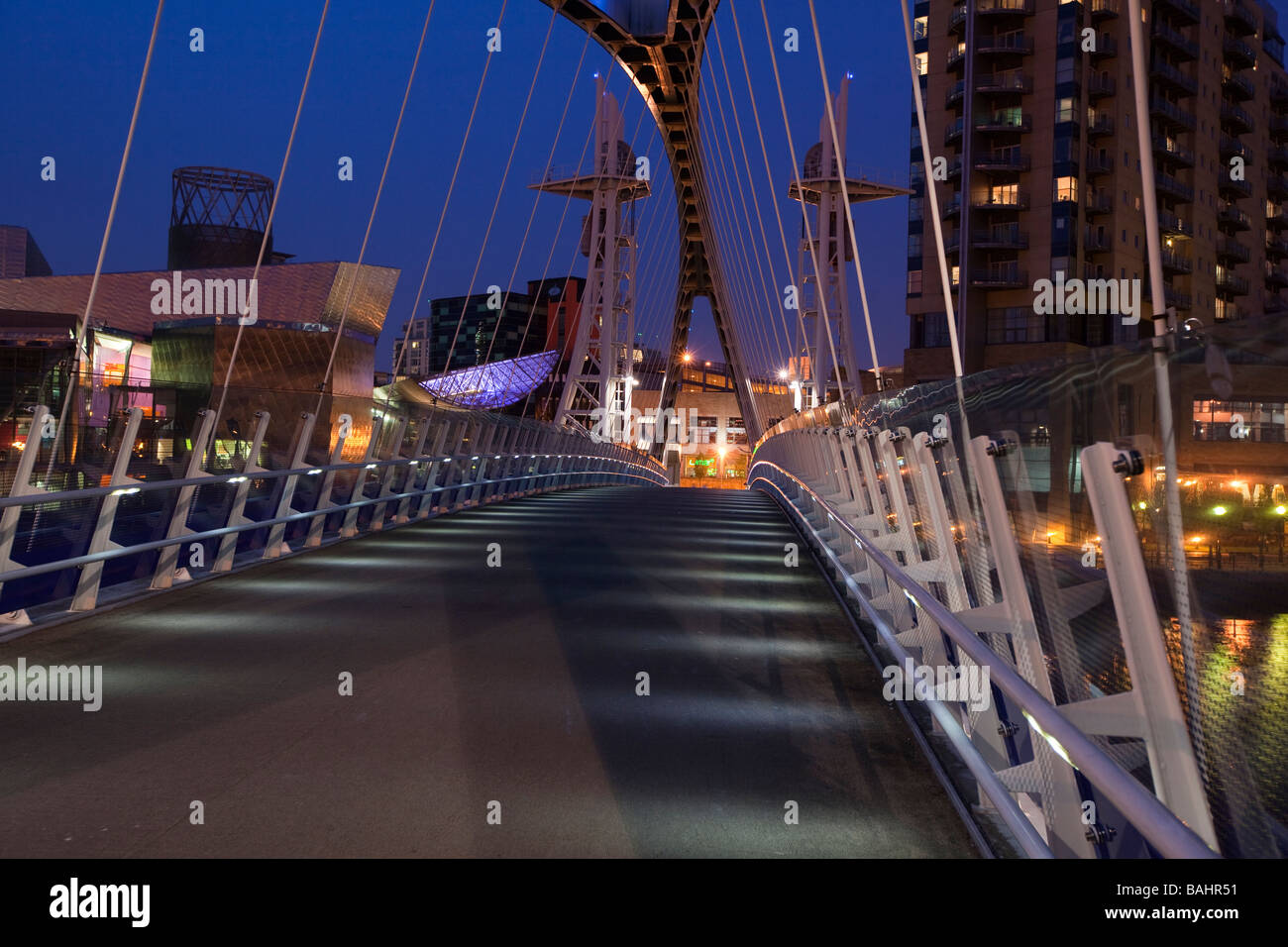 UK England Salford Quays Lowry Centre Milennium footbridge over Manchester Ship Canal at night Stock Photo