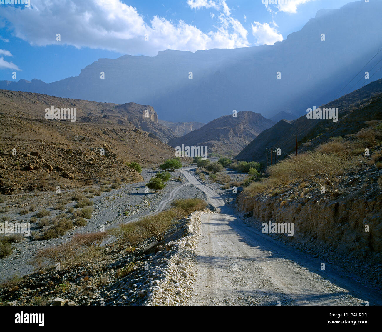 Gravel road going through the Western Hajar Mountains Schotterstrasse durch die Bergregion des westlichen Hajar Gebirges Stock Photo