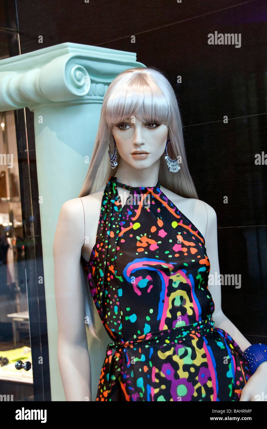 View of a female mannequin inside a boutique store through the window ...