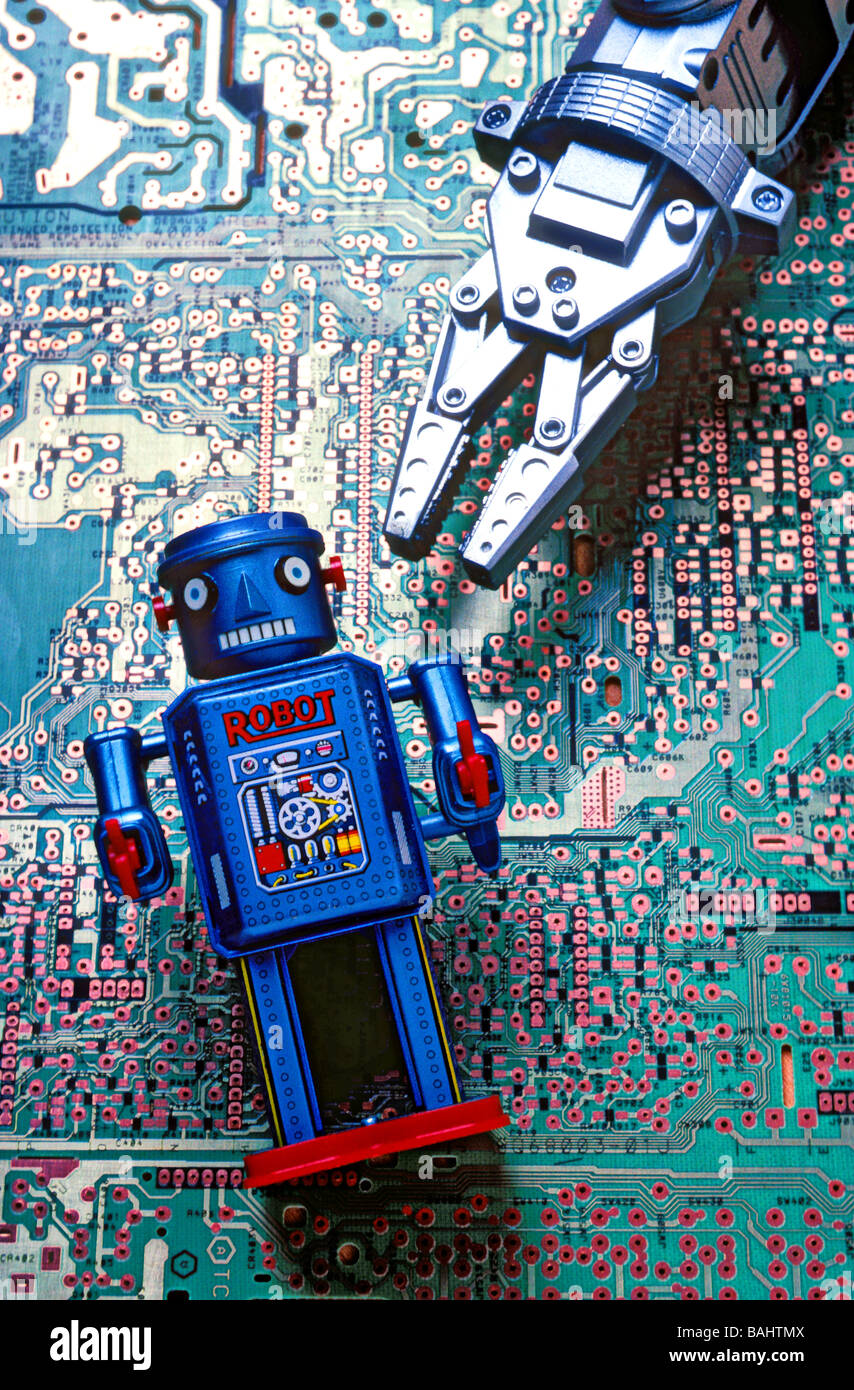 Toy robot on circuit board Stock Photo
