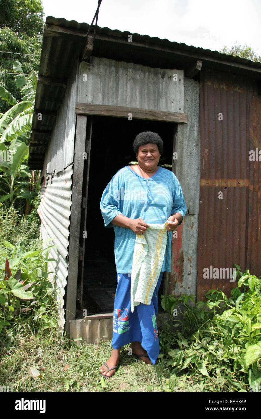 Fijian woman outside hut Stock Photo