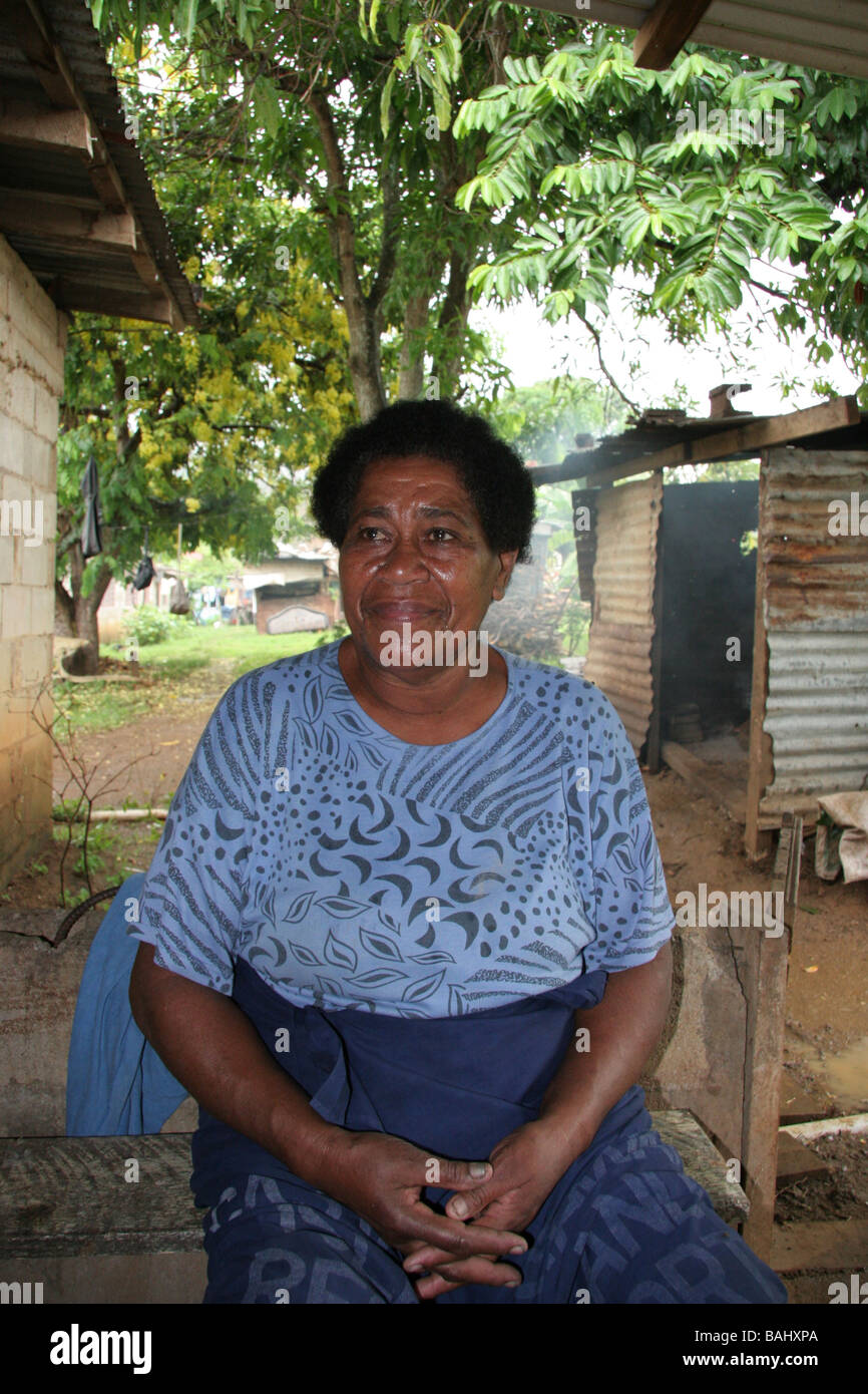 Fijian lady outside hut in village Stock Photo