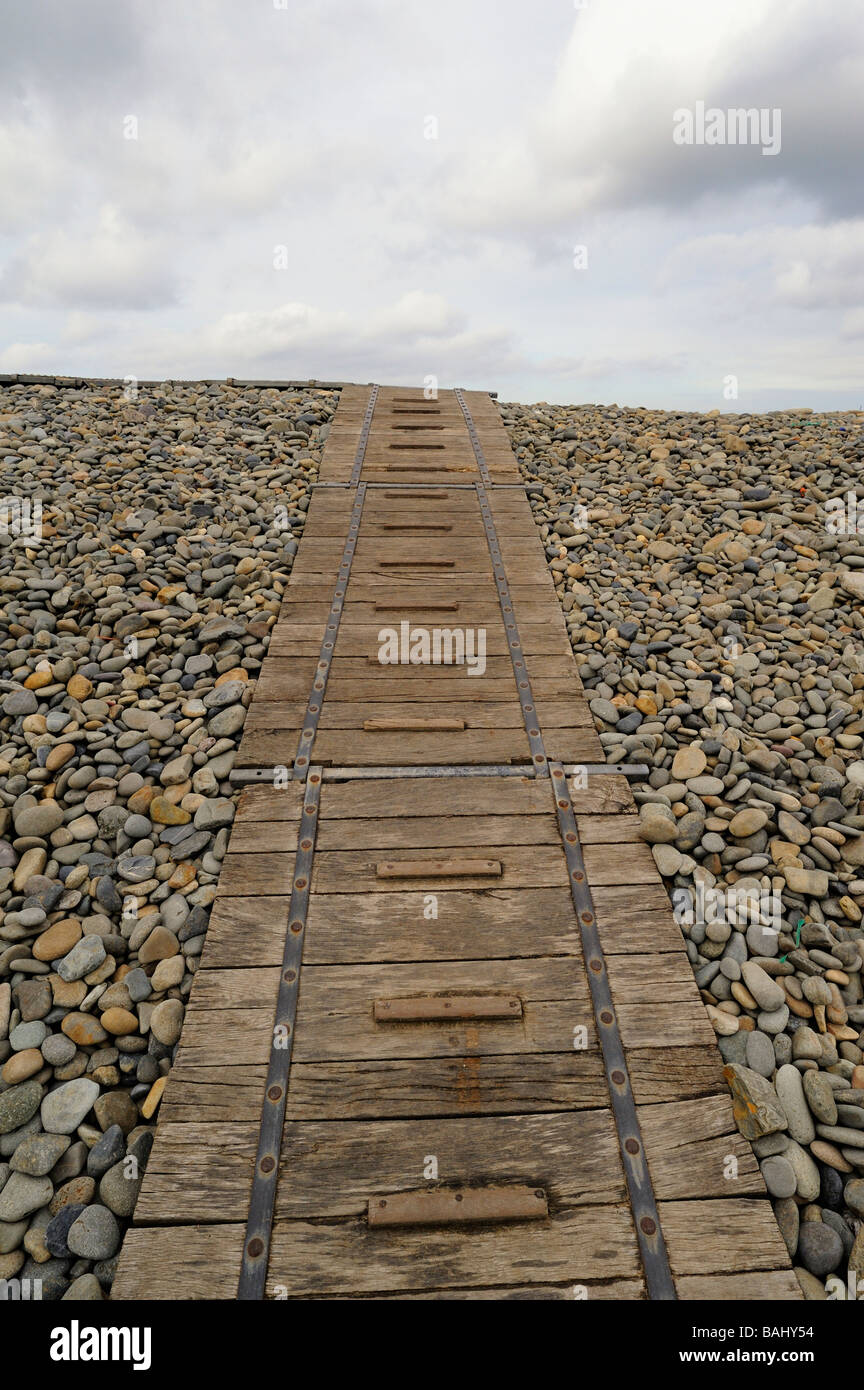 A wooden board walk over the pebble beach at Newgale in Pembrokeshire Wales UK Stock Photo