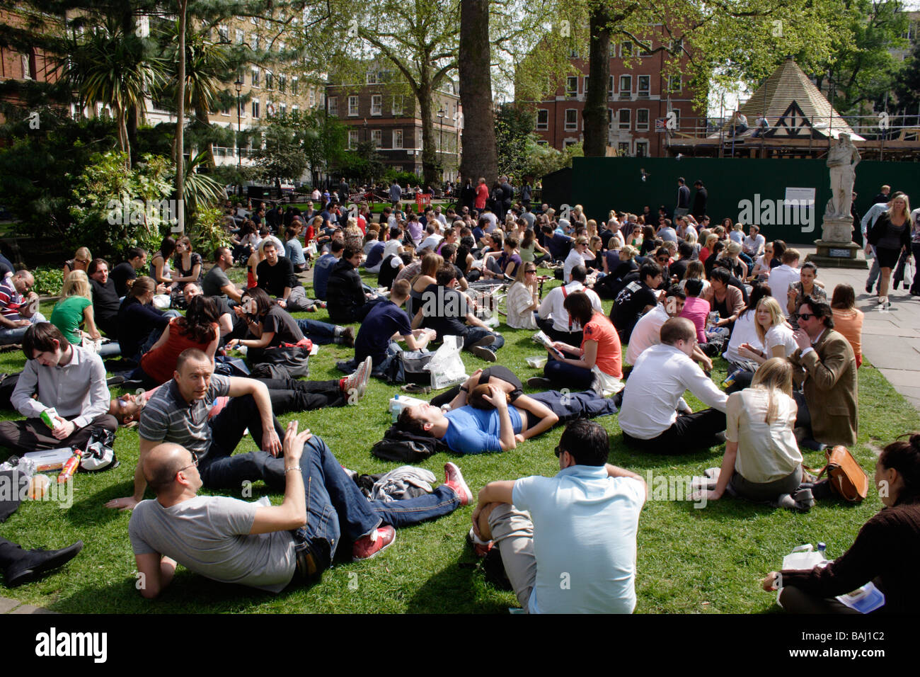 People and office workers relaxing at lunchtime Soho Square London April 2009 Stock Photo