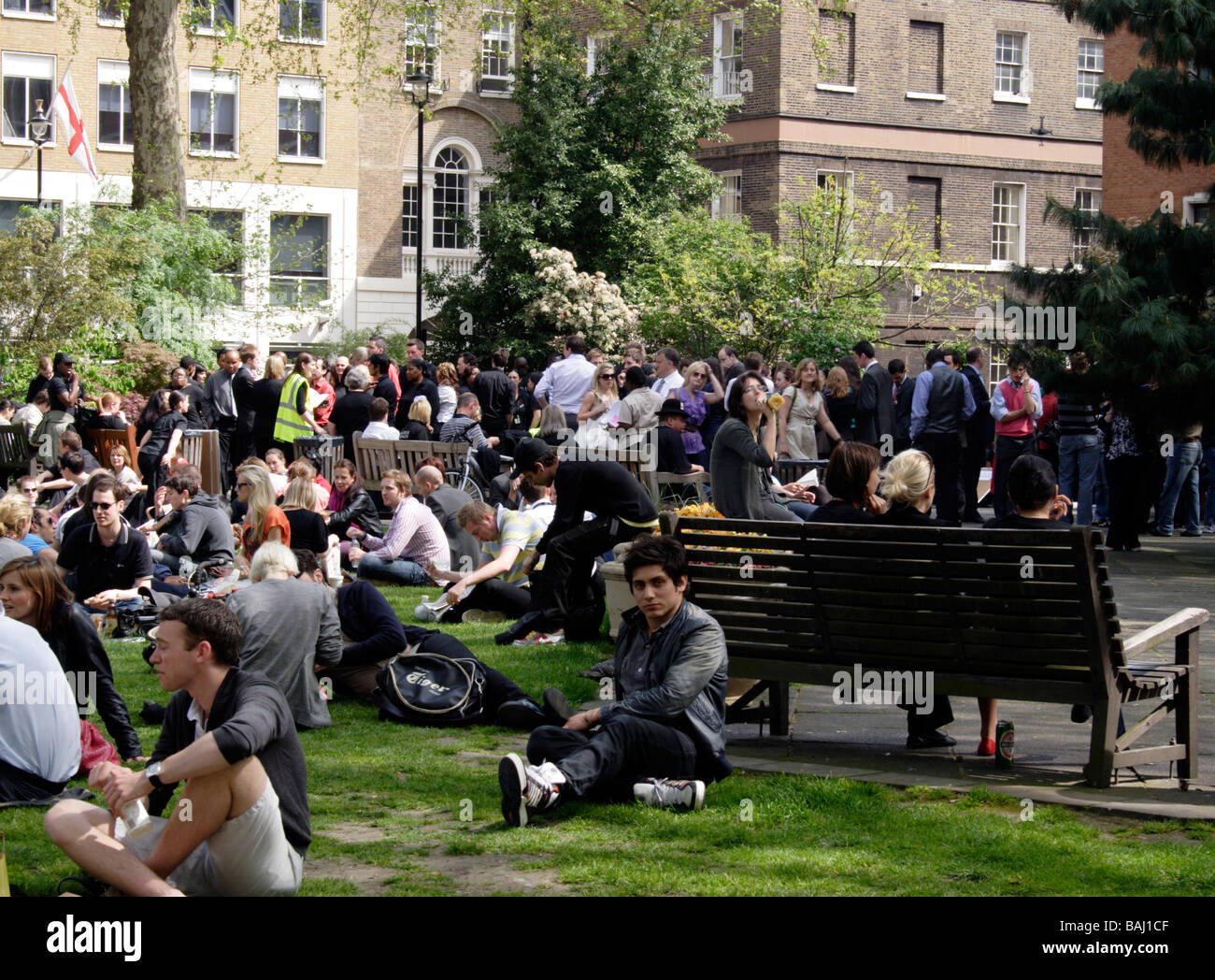 People and office workers relaxing at lunchtime Soho Square London April 2009 Stock Photo