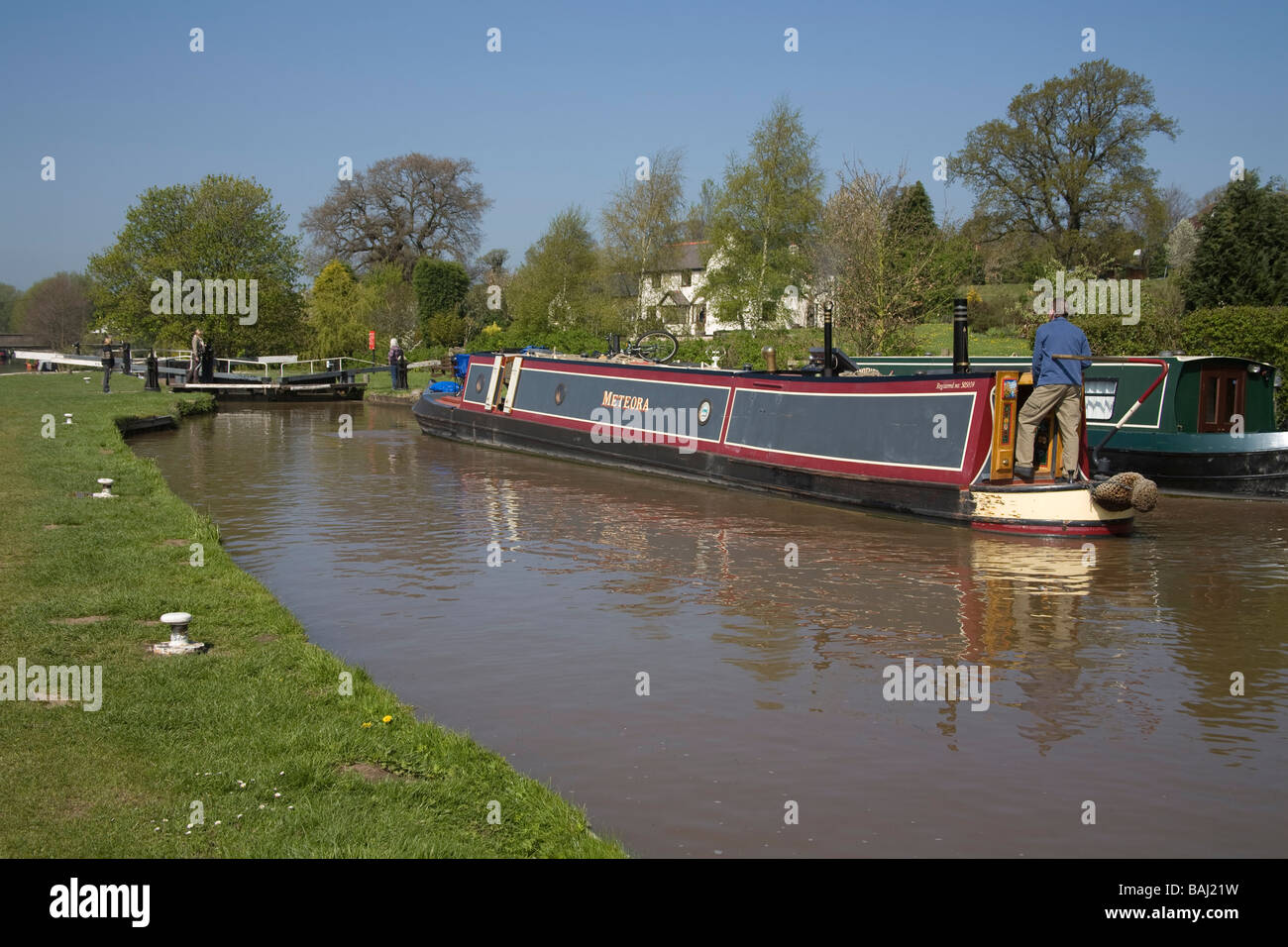 Beeston Cheshire England UK April Man steering his narrowboat towards