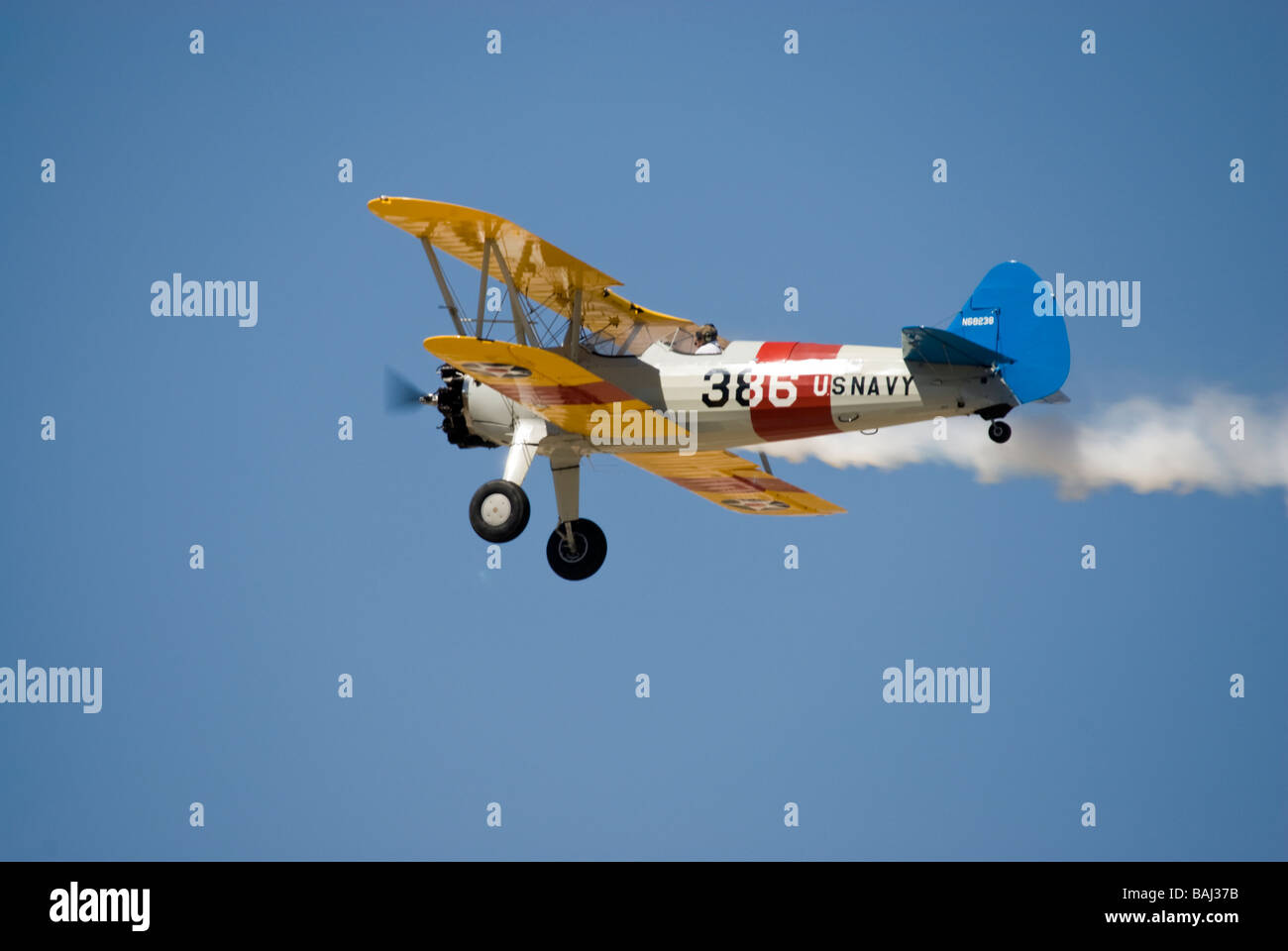 A US Navy version of the Stearman biplane trainer - in flight Stock Photo