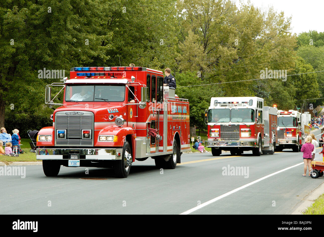 A fire department vehicle being driven in a fire muster parade Stock