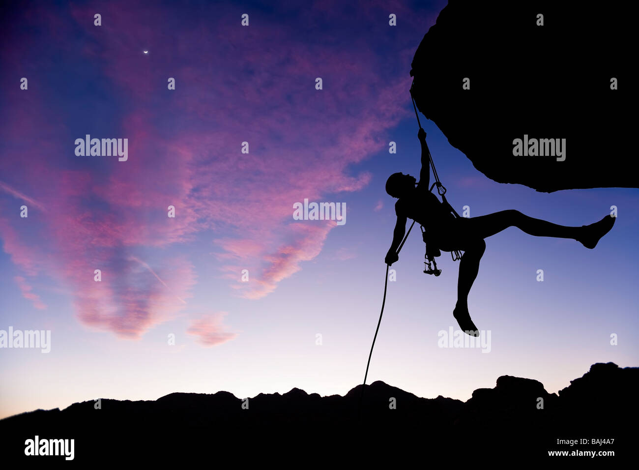Rock climber rappelling. Stock Photo