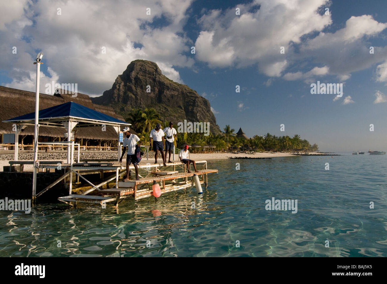 Natives at pier Le Paradis hotel Mauritius Africa Stock Photo