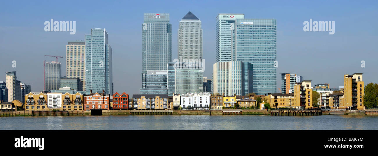 Landmark skyscraper offices and riverside apartments in the Canary Wharf development area in East London Docklands beside River Thames in Isle of Dogs Stock Photo