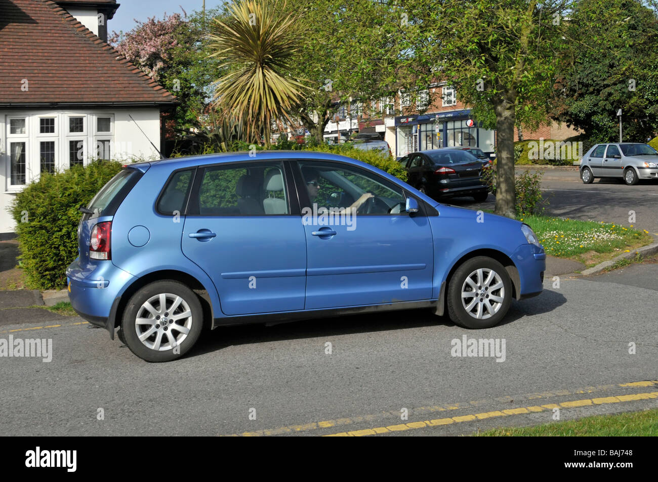 cafe Leger marketing Woman driving a Volkswagen Polo car moving away from kerb Stock Photo -  Alamy