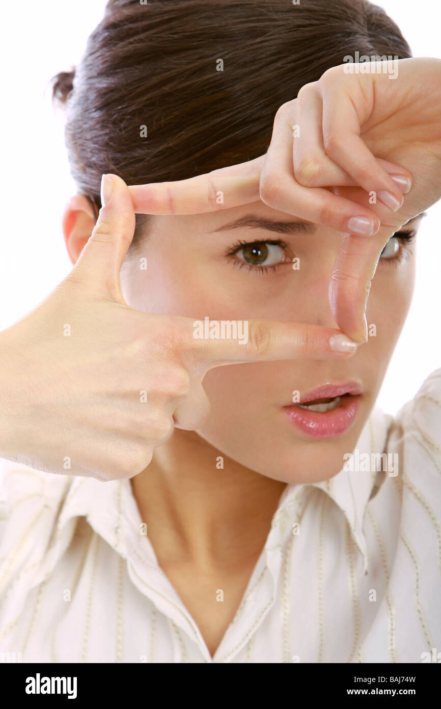 Woman looking through hands Stock Photo