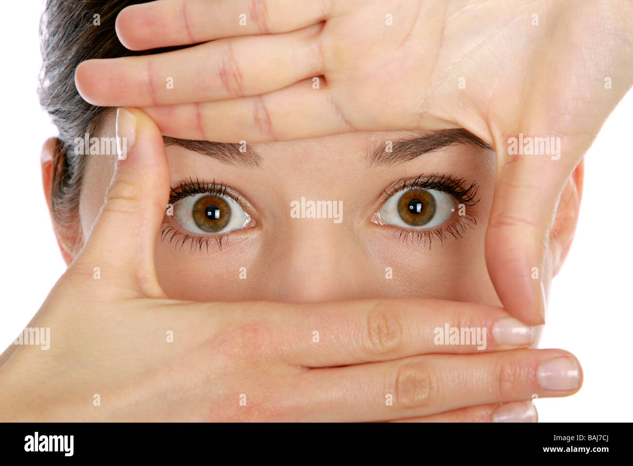 Woman looking through hands Stock Photo