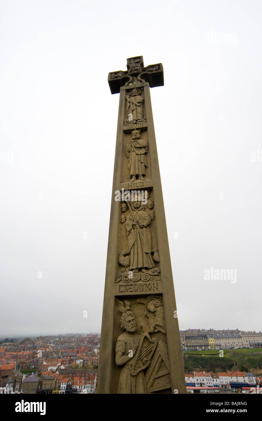 The twenty foot high cross commmemorating Caedmon with Whitby in the background. Stock Photo