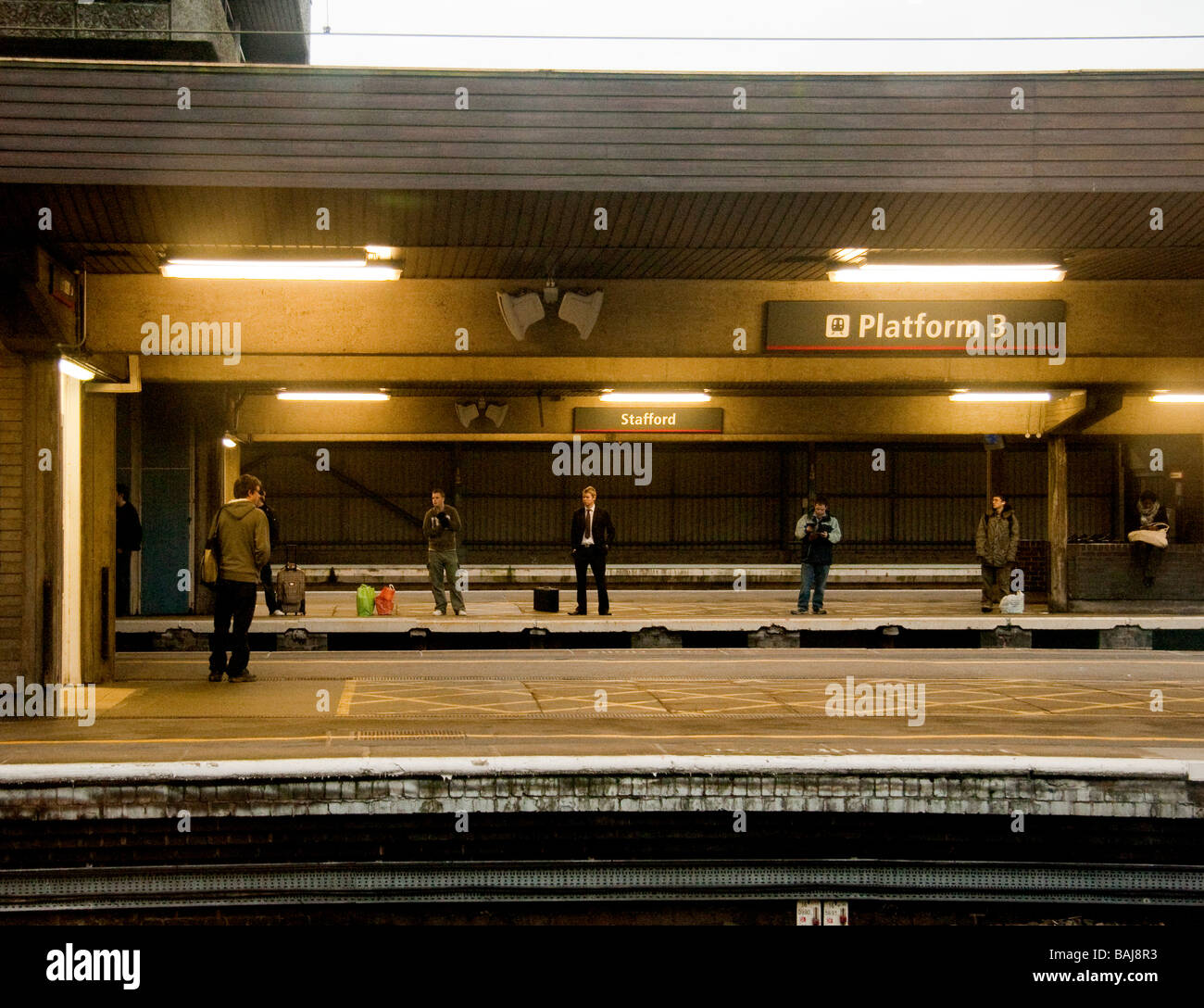Passengers waiting a train station platform in Stafford Stock Photo Alamy