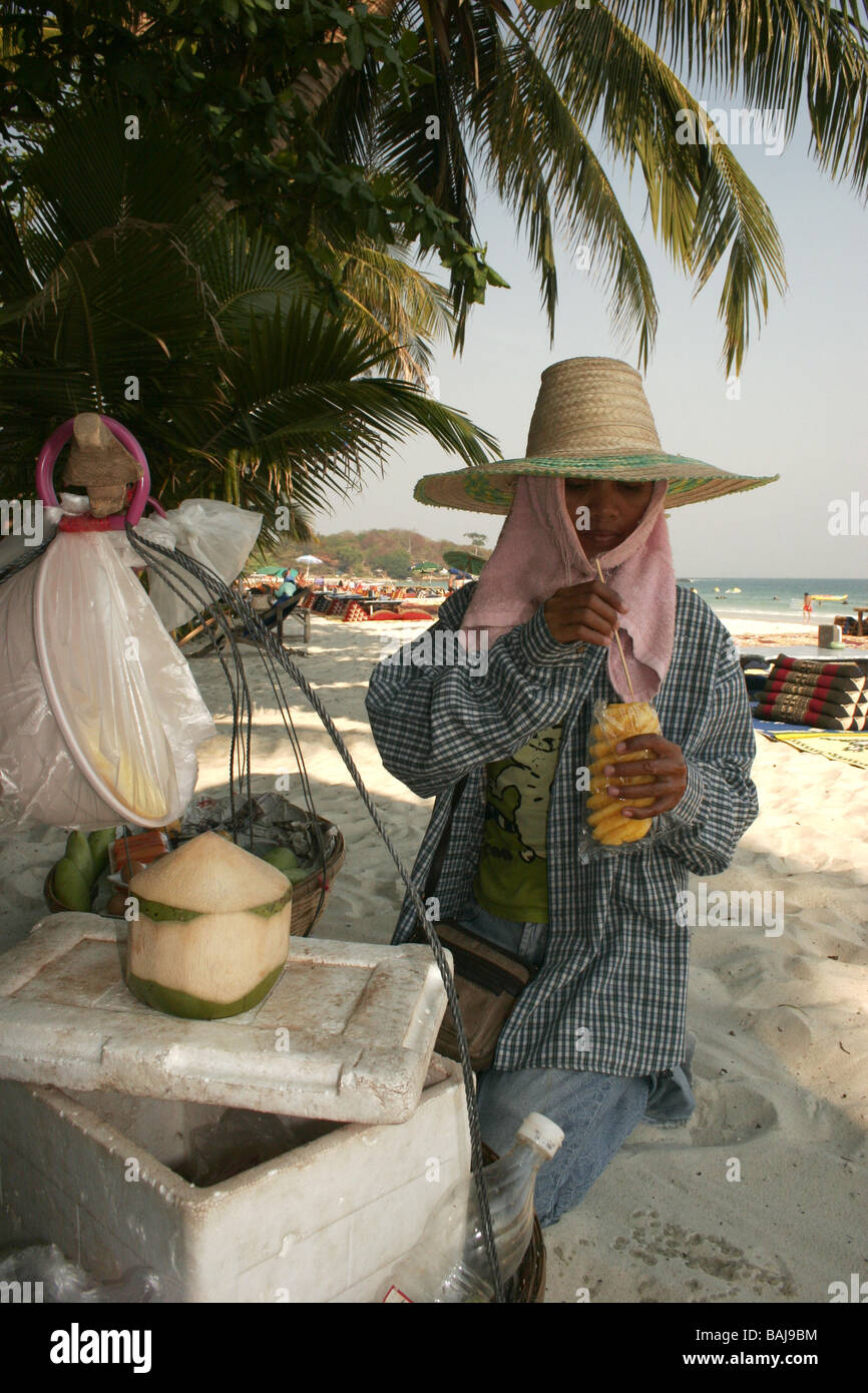 Thai woman selling fresh fruits on beach in Ko Samet island Thailand Stock Photo