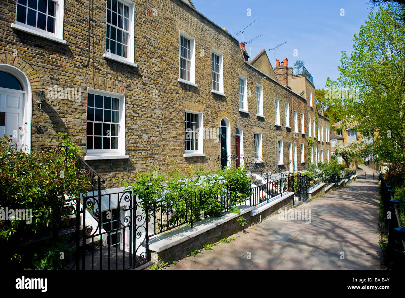 Spring in Hampstead Village , picturesque old Georgian terraced cottages with wooden sash windows & gardens in Flask Walk Stock Photo