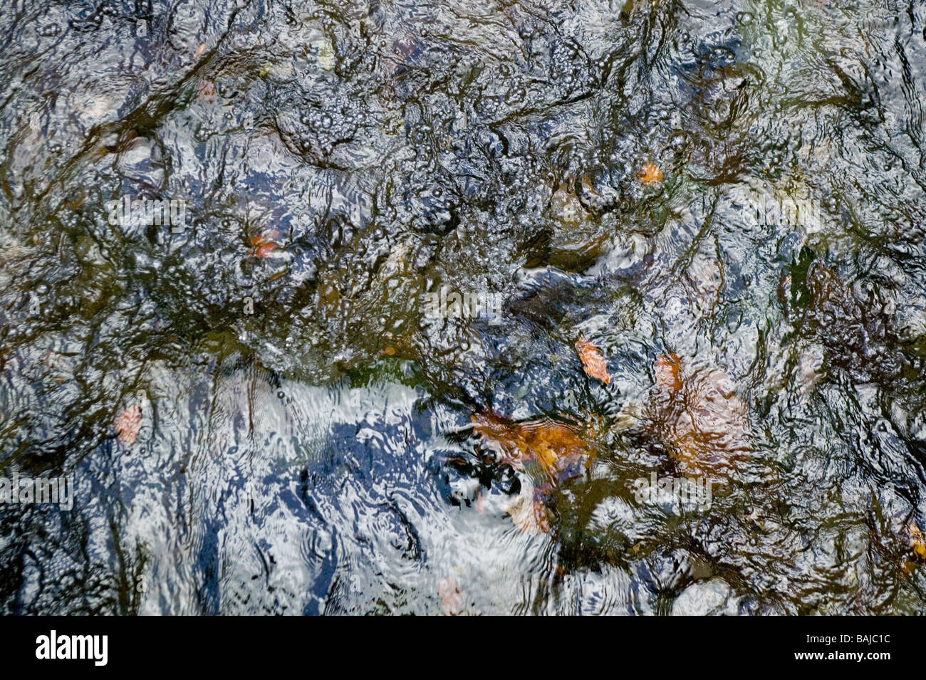An image of the surface of water in a fast running river in autumn in the Lake District Stock Photo