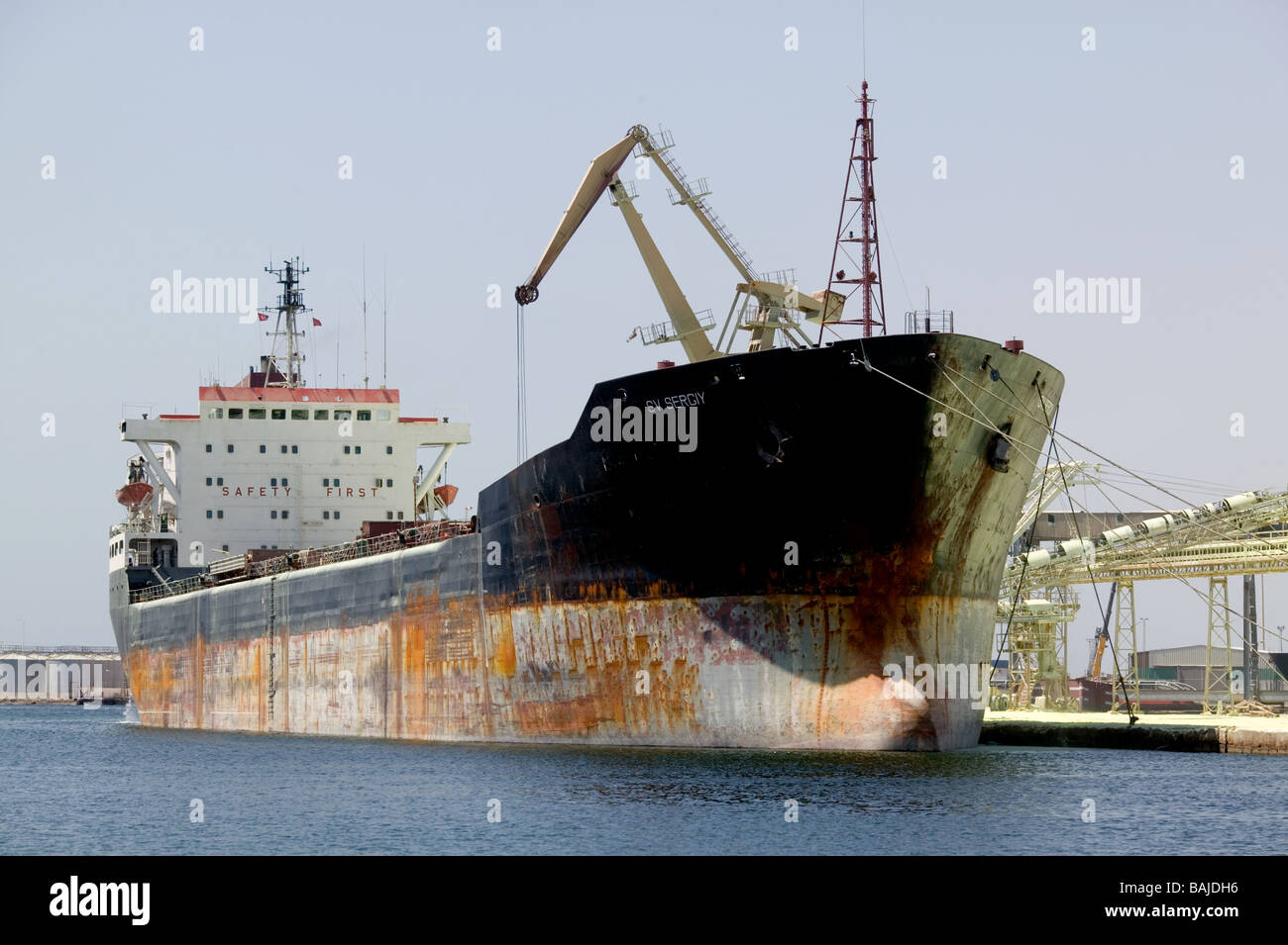A large ship loading with locally mined sulphur  in the Tunisian port of Sfax Stock Photo
