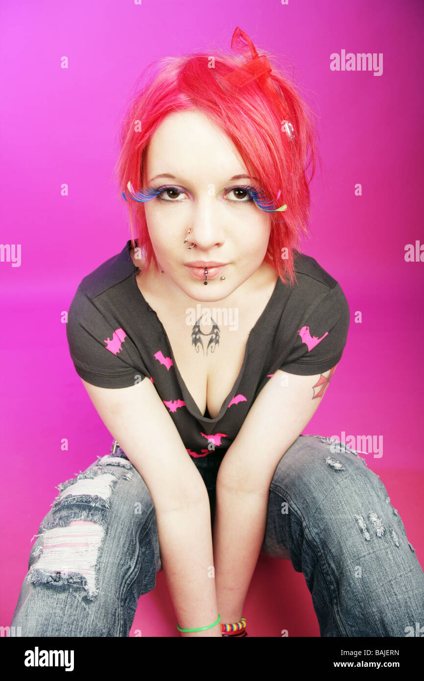 Pretty teenage cyber goth punk sitting in a studio Stock Photo