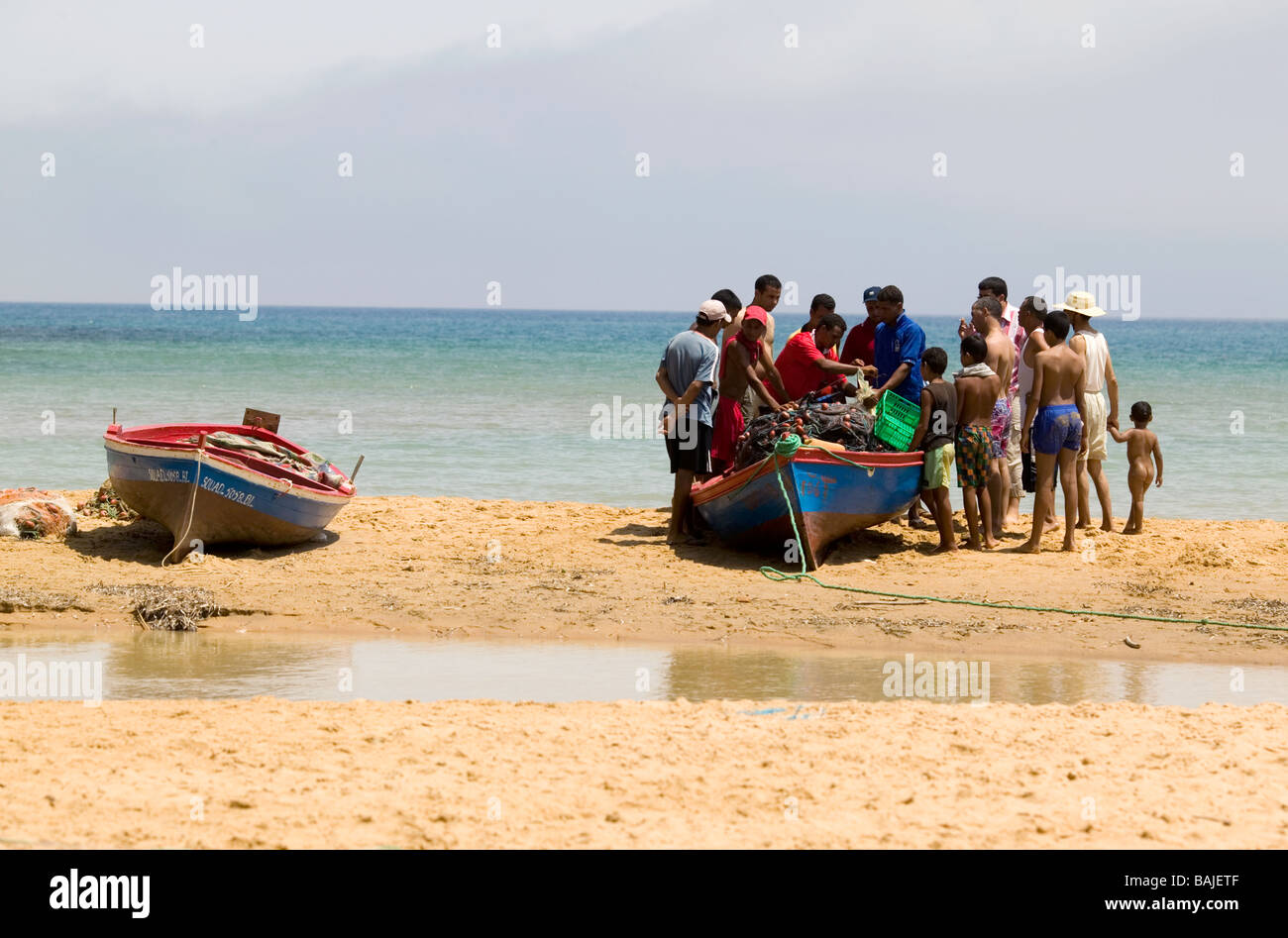 Fishermen unloading catch on the beach at Cap Serat in Tunisia Stock Photo