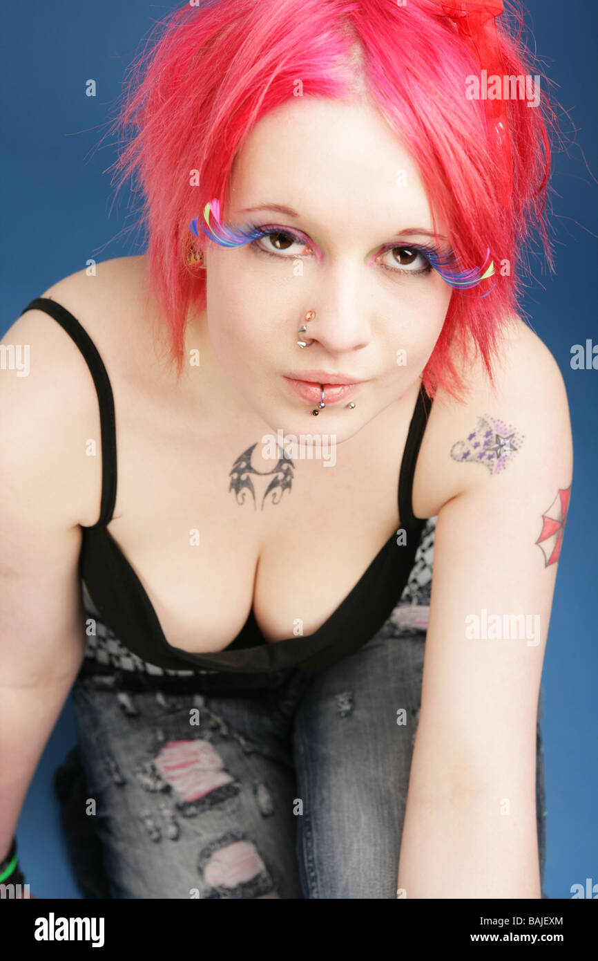 Pretty teenage cyber goth punk sitting in a studio Stock Photo