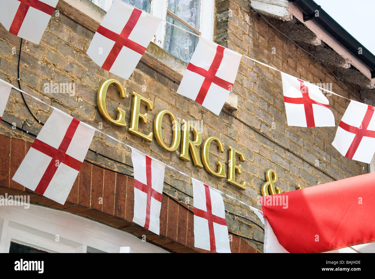 The George and Dragon pub with flags out on St Georges Day, Snailwell, Cambridgeshire Stock Photo