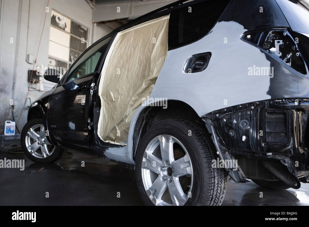 Damaged sports utility vehicle in garage Stock Photo Alamy