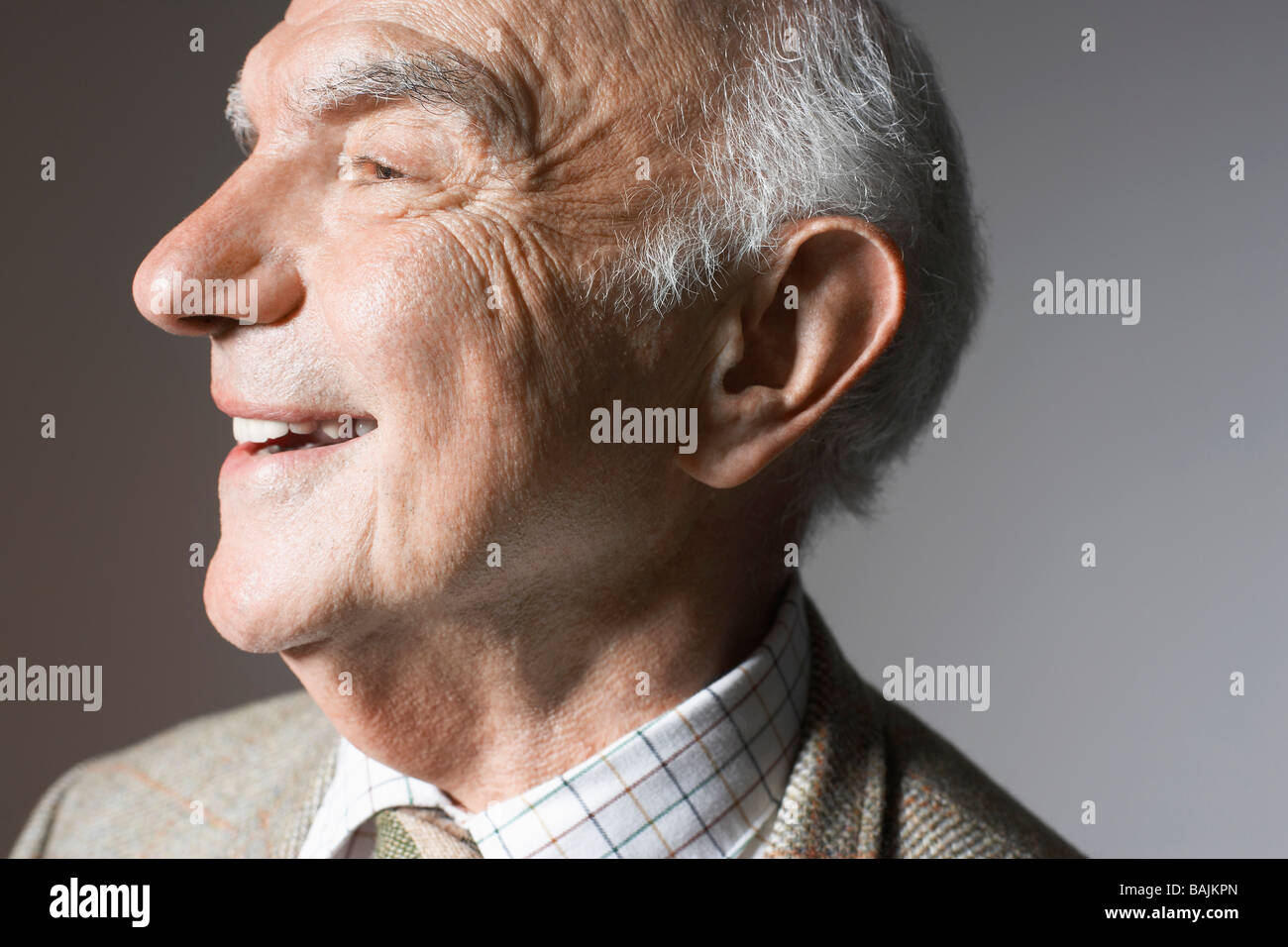 Senior man smiling in studio, close up Stock Photo