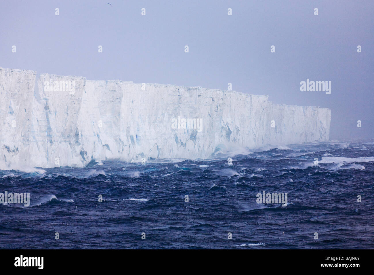 High winds and blue tabular iceberg Southern Ocean Antarctica Stock Photo