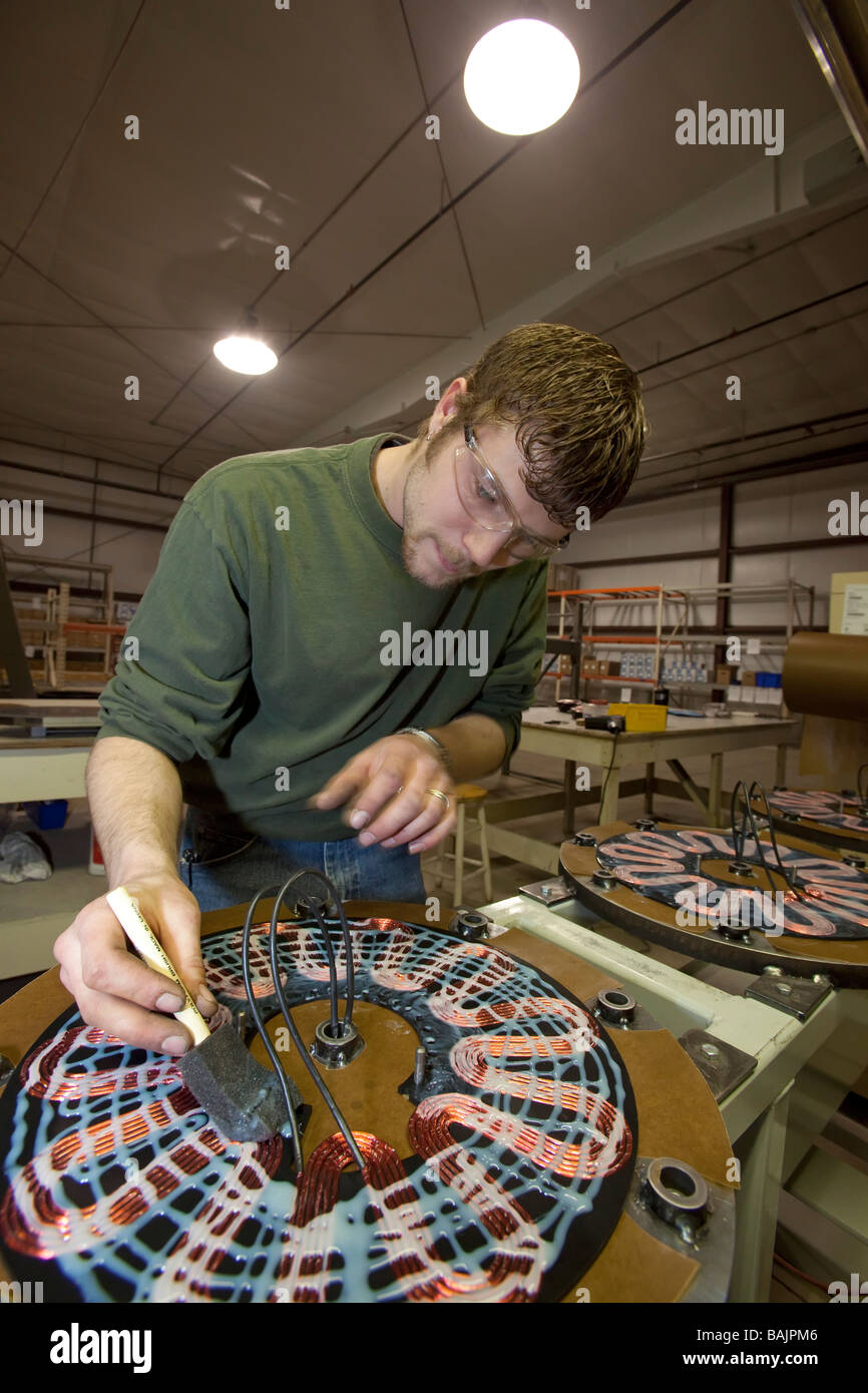 Workers manufacture Windspire wind turbines in a former auto parts factory. Stock Photo