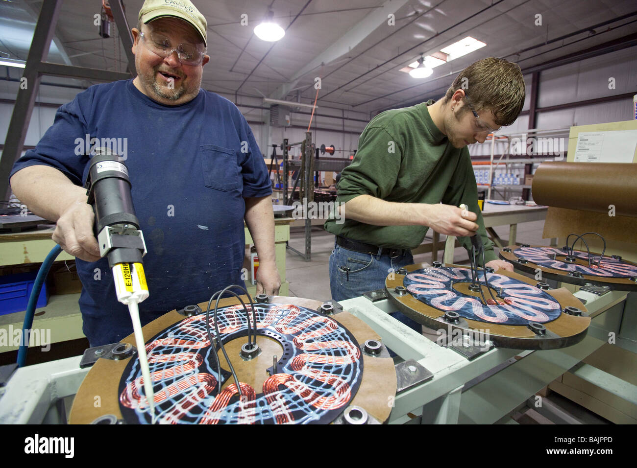 Workers manufacture Windspire wind turbines in a former auto parts factory. Stock Photo