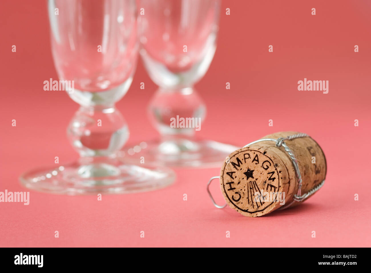 Champagne cork and two short stemmed champagne glasses Stock Photo