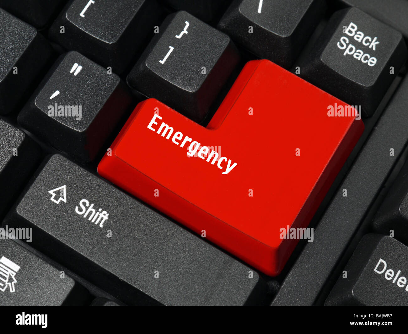 Closeup of computer keyboard key in red color spelling Emergency Stock Photo