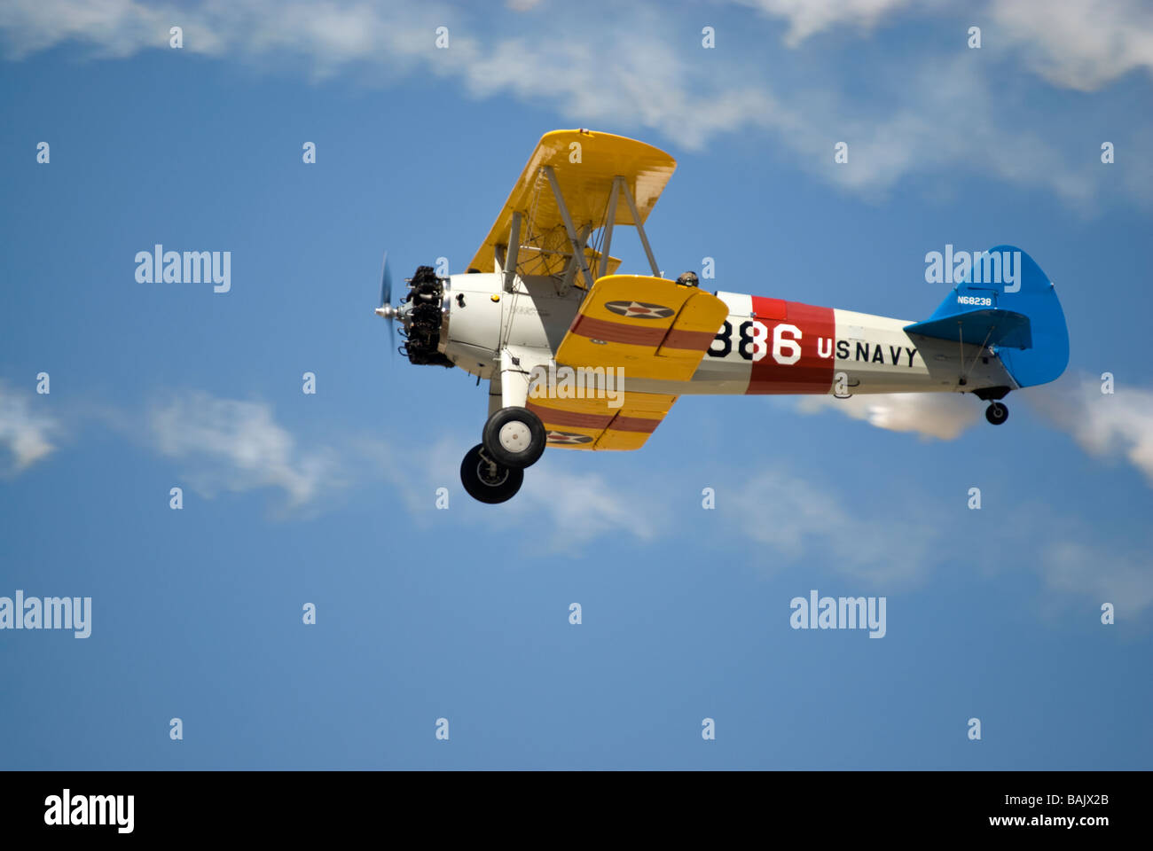 A US Navy version of the Stearman biplane trainer - in flight Stock Photo