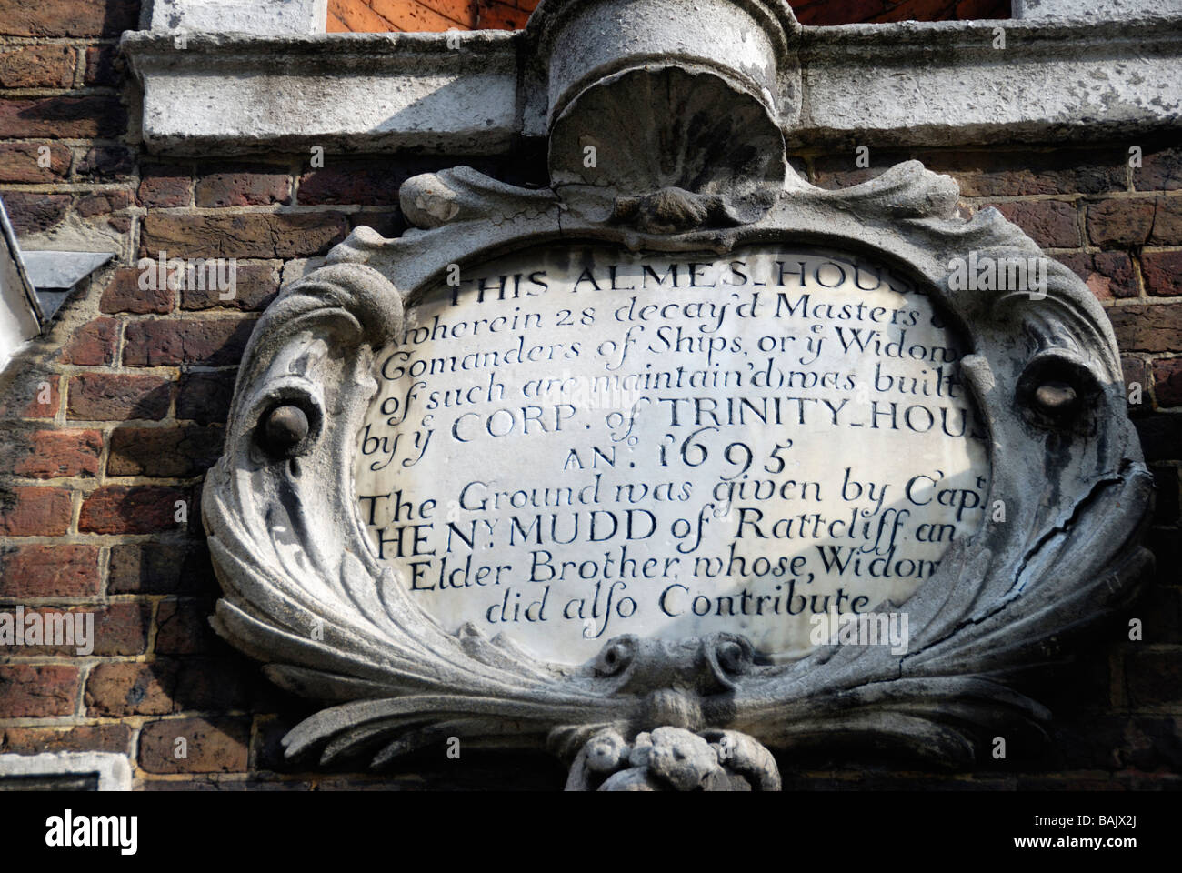 Stone plaque on exterior wall of Trinity Green Almshouses in Mile End Road Whitechapel London Stock Photo