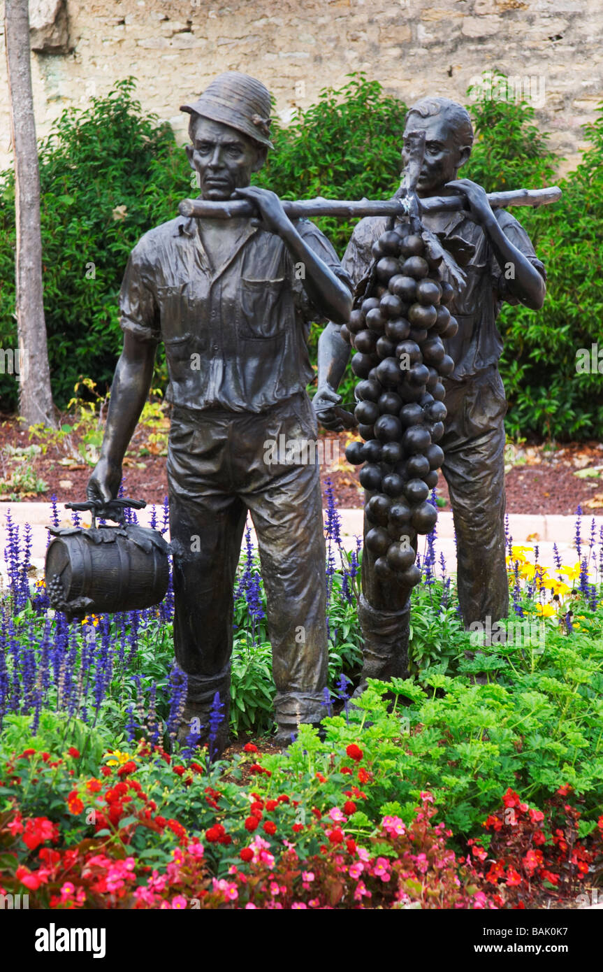 statue of men carrying giant grape bunch in village square marsannay cote de nuits burgundy france Stock Photo