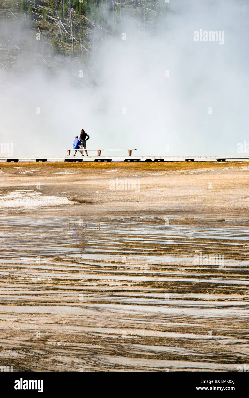 tourists at Midway Geyser Basin in Yellowstone National Park Stock Photo