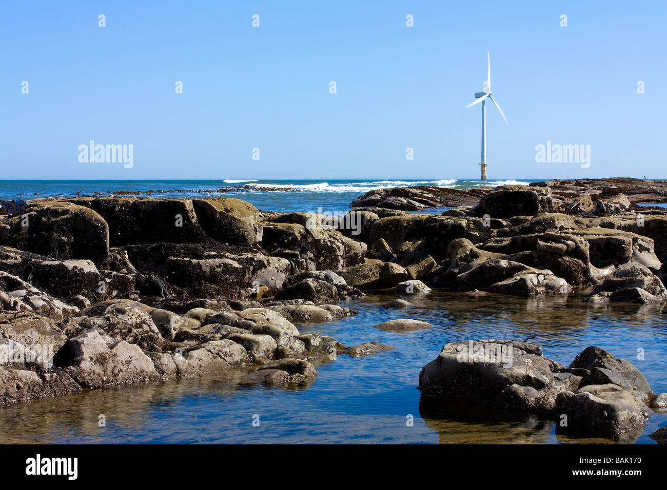 Cambois beach North of Blyth Northumberland showing small offshore wind turbine farm Stock Photo