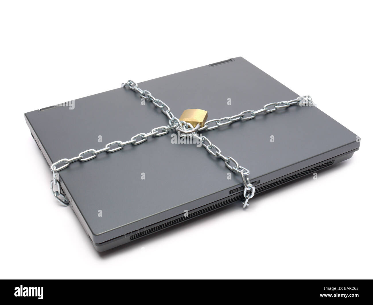 Closed laptop wrapped around with metal chain and locked with padlock shot over white Stock Photo