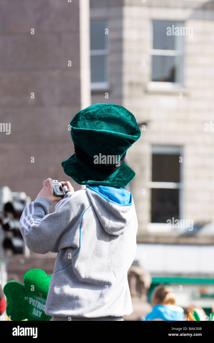 Young boy takes picture of St Patricks day Parade Dublin Ireland Stock Photo