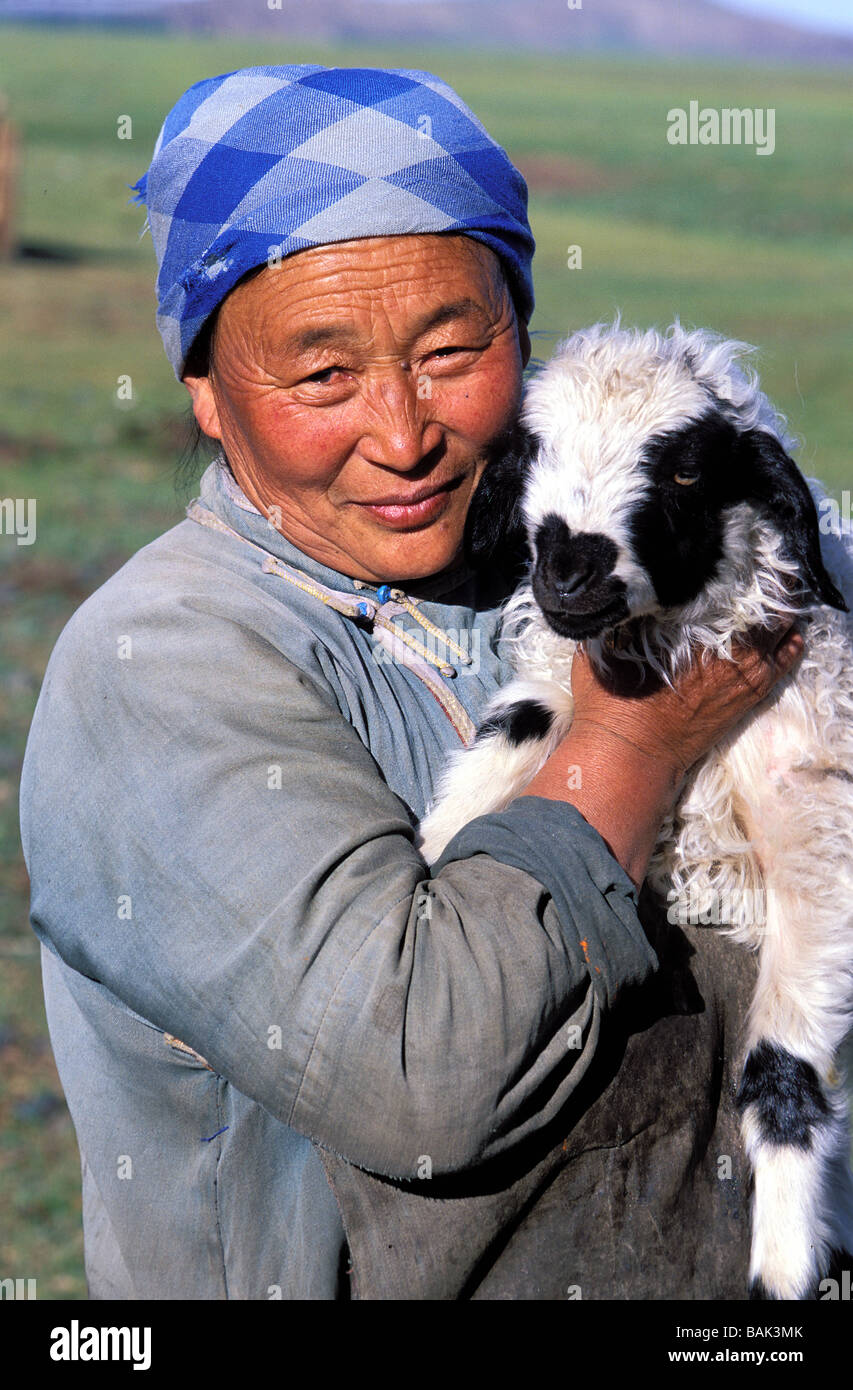 Mongolia, Arkhangai province, portrait of a woman with a  young goat Stock Photo