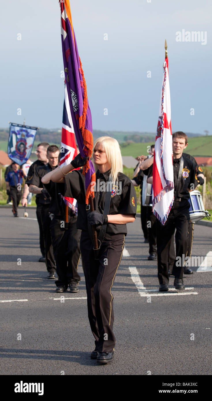 Flag bearers of a Scottish Protestant Flute Band parade on a Suburban street. Stock Photo