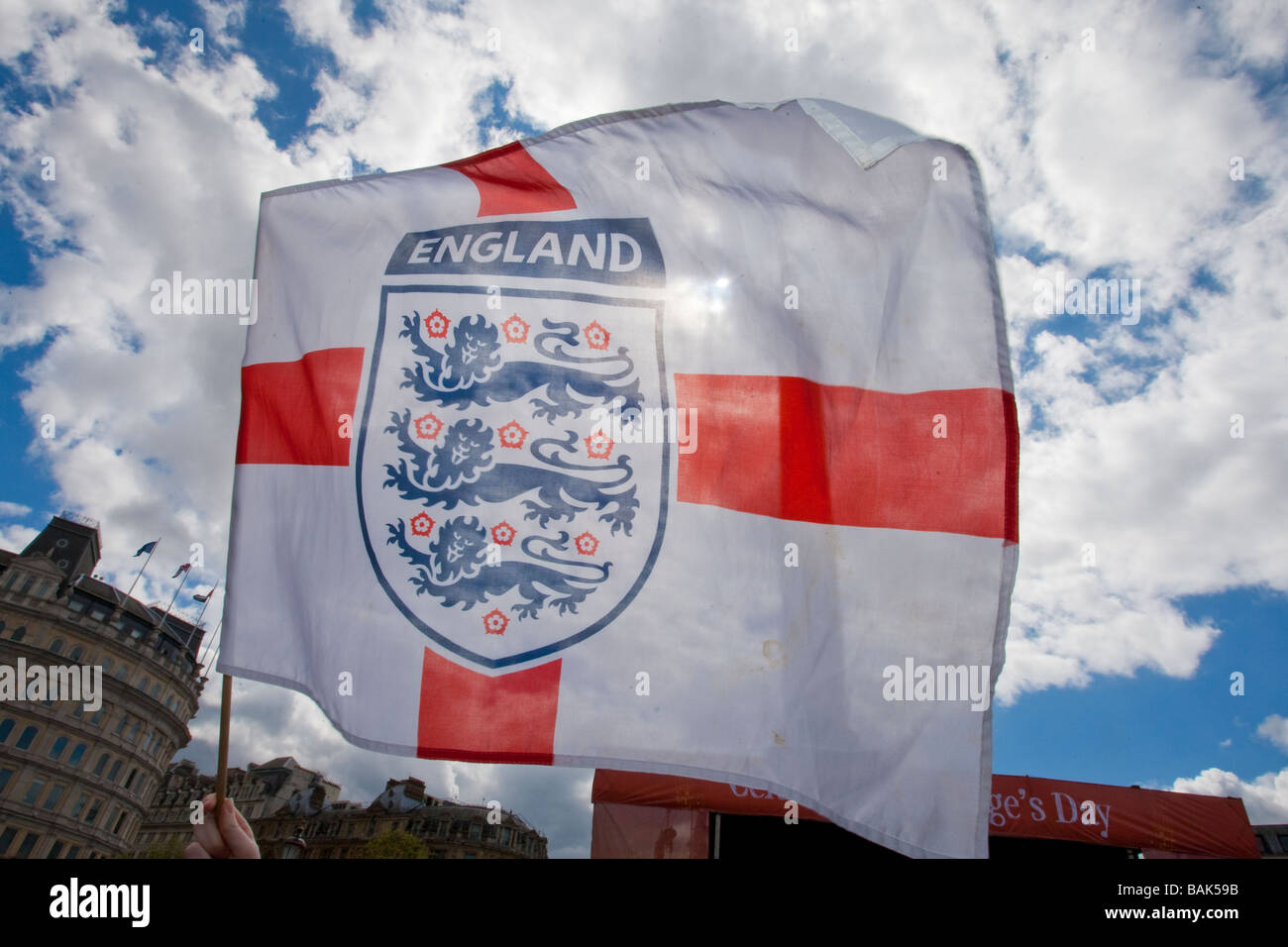 Backlit England flag being waved in Trafalgar Square during St George's Day celebrations. Stock Photo