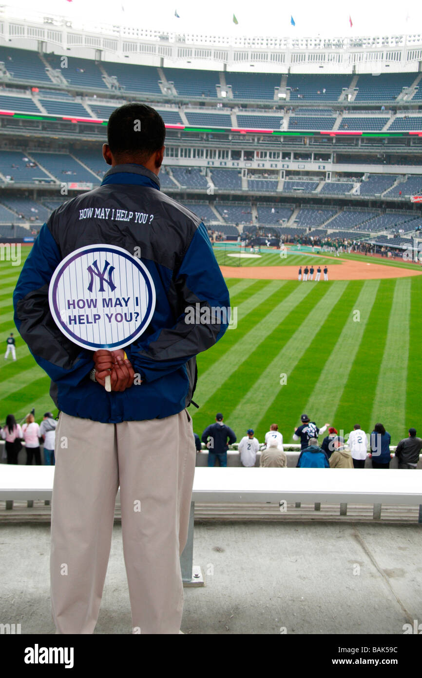 A worker looking out at the outfield during batting practice at the new