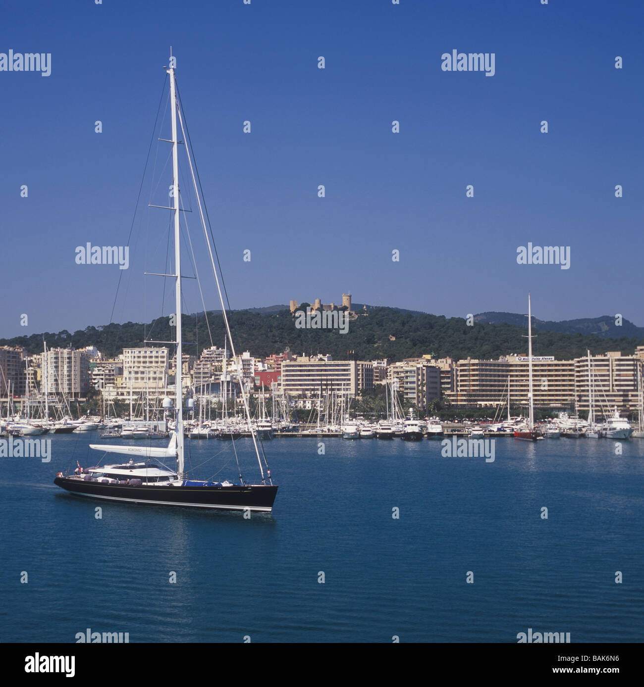 Sailing Yacht 'Kokomo' with historic Bellver Castle and Paseo Maritimo in the background, Palma de Mallorca Stock Photo