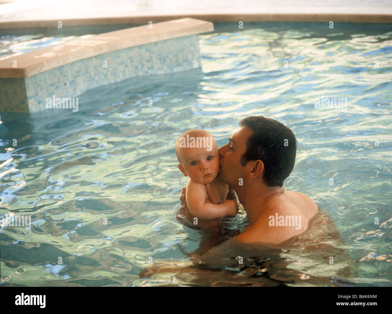 Father with baby boy in swimming pool, France Stock Photo